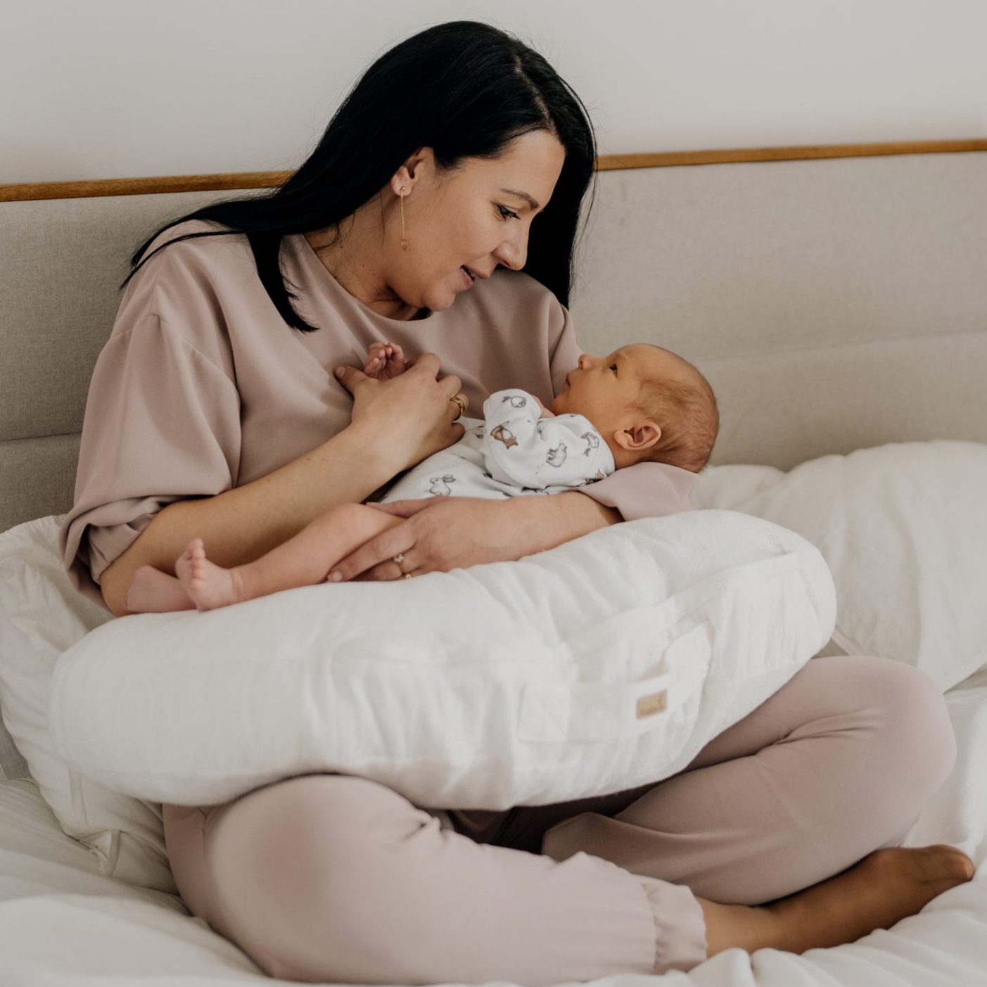 Baby sleeping on breastfeeding pillow hotsell